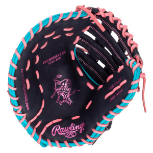 Inside view of a dark navy baseball glove with pink and teal lacing, showing the "Rawlings" logo and "Heart of the Hide" emblem.