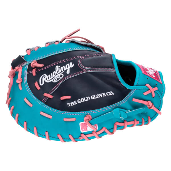 Side view of a teal and black Rawlings baseball glove with pink lacing and "THE GOLD GLOVE CO." text.