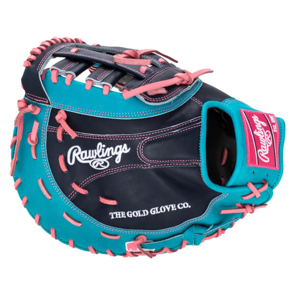 Top-down view of a navy and teal baseball glove with pink lacing, featuring "Rawlings" and "THE GOLD GLOVE CO." text.