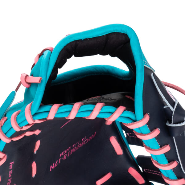 Close-up of a navy baseball glove with turquoise and pink lacing, showing the "PROFM18-1/2 INCH" text.