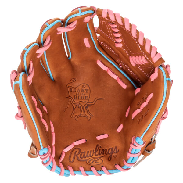 Top-down view of a brown baseball glove with pink and blue lacing, featuring "Rawlings" and "Heart of the Hide" logos.