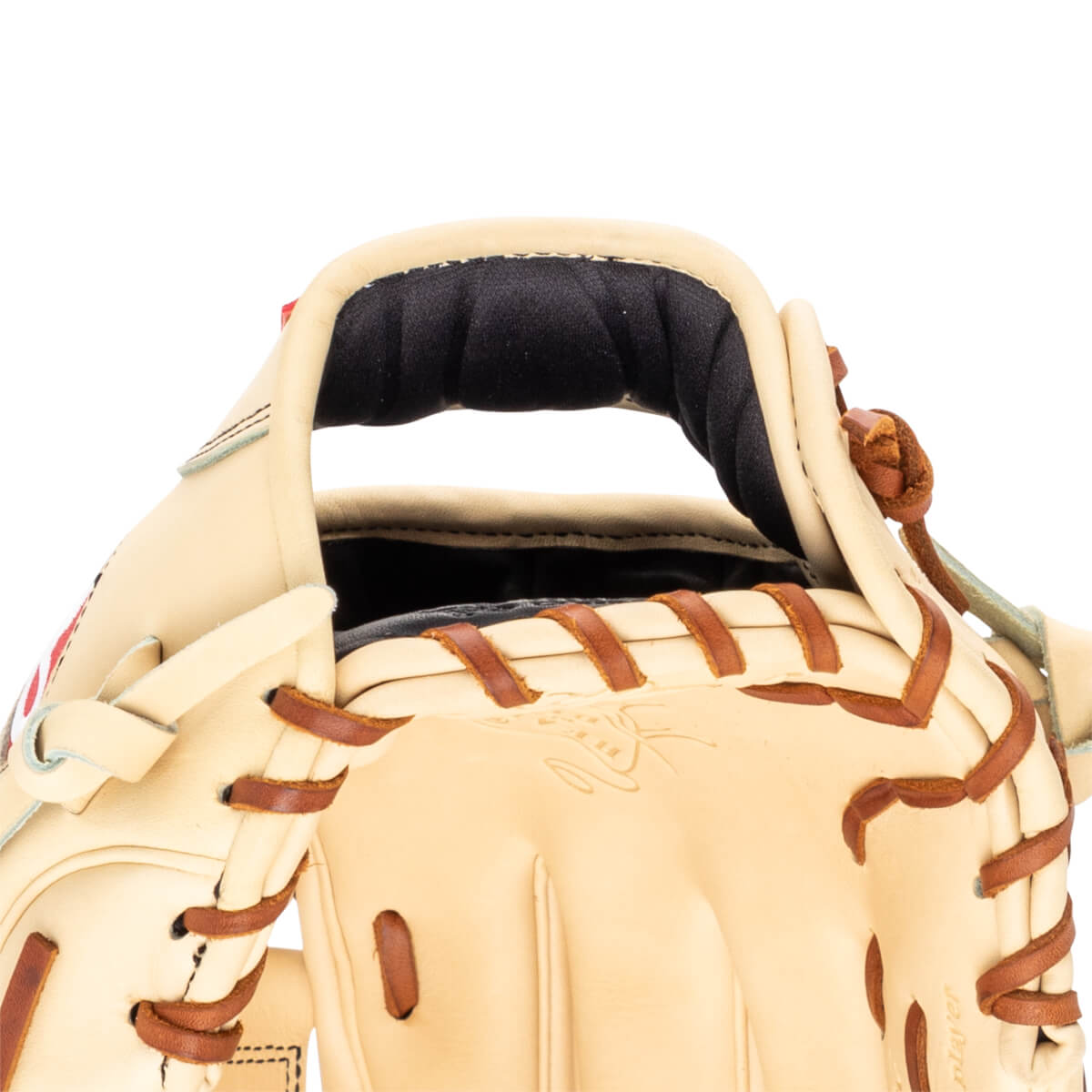 Close-up of a tan baseball glove showing the padded wrist area, tan lacing, and embossed "player" text.