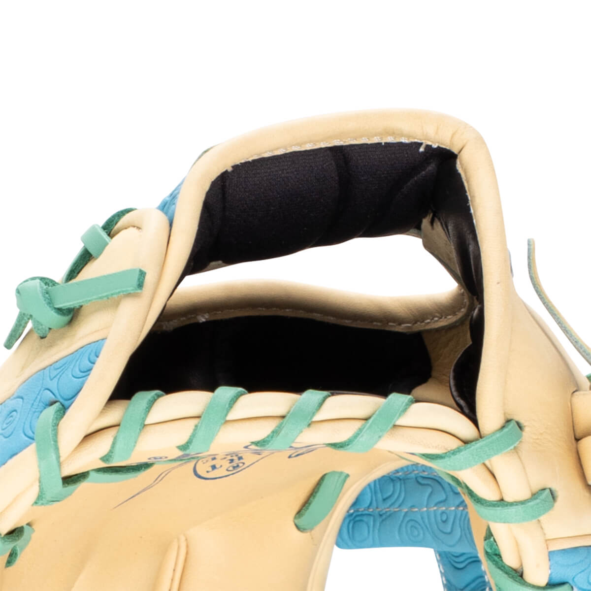 Close-up of a tan baseball glove with teal lacing and a blue textured interior.