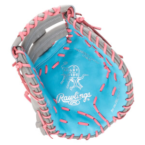 Interior view of a blue Rawlings glove with pink lacing and "HEART of the HIDE" logo.