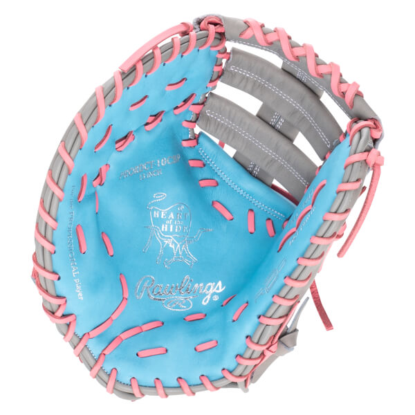 Top-down view of a blue and gray baseball glove with pink lacing, showing the Rawlings logo and "HEART of the HIDE".