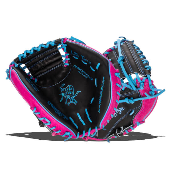 Interior view of a black baseball glove with bright pink and blue lacing, showing the "Heart of the Hide" logo.