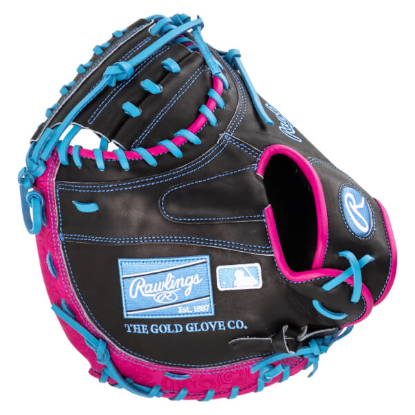 Close-up of a black baseball glove with bright pink and blue lacing, featuring "Rawlings" and "THE GOLD GLOVE CO." text.