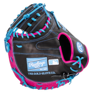 Close-up of a black baseball glove with bright pink and blue lacing, featuring "Rawlings" and "THE GOLD GLOVE CO." text.