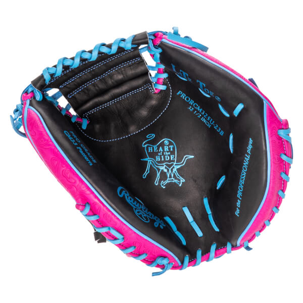Interior view of a black baseball glove with pink and blue accents, showing the "Heart of the Hide" logo and "Rawlings" text.
