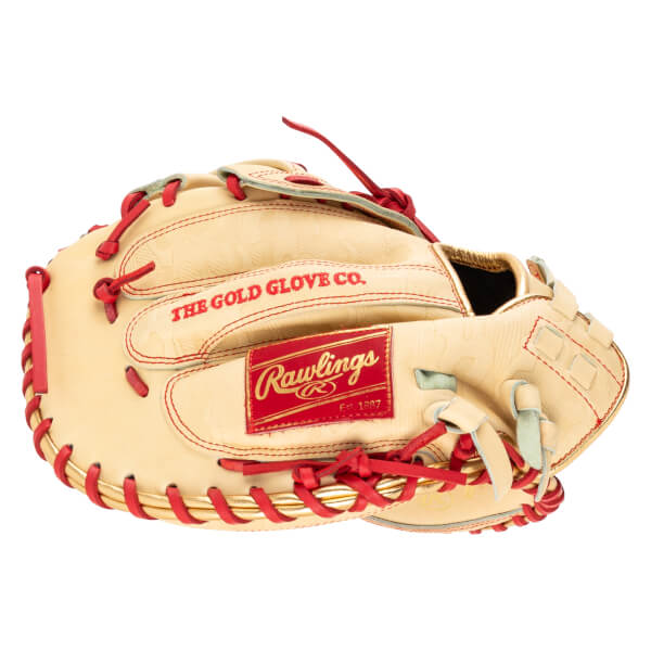 Top-down view of a tan baseball glove with red lacing and gold trim, featuring "THE GOLD GLOVE CO." and "Rawlings Est. 1887" text.