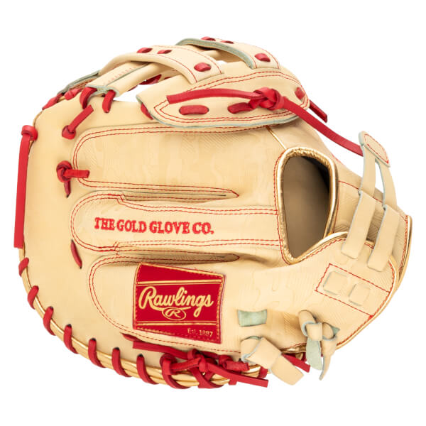 Side view of a tan baseball glove with red lacing, a red Rawlings logo, and gold trim.