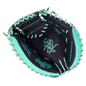 Inside view of a black baseball glove with teal lacing, showing the "Rawlings" logo and "HEART of the HIDE" emblem.
