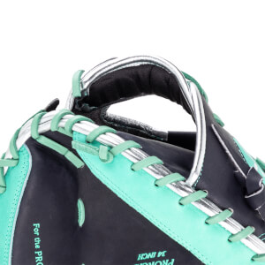 Close-up of a baseball glove showing teal lacing, silver accents, and "For the PRO" text.