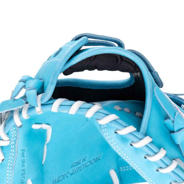 Close-up of a bright blue baseball glove, showing white lacing and text "For the PRO".