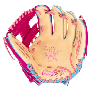 Front view of a tan baseball glove with pink webbing and blue and pink laces, featuring pink Rawlings and Heart of the Hide logos stamped on the palm.