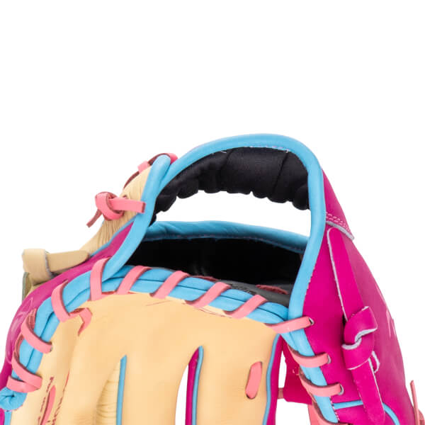 Close-up of the wrist opening showing a black padded strap, hot pink and tan leather, and light blue binding with pink laces.