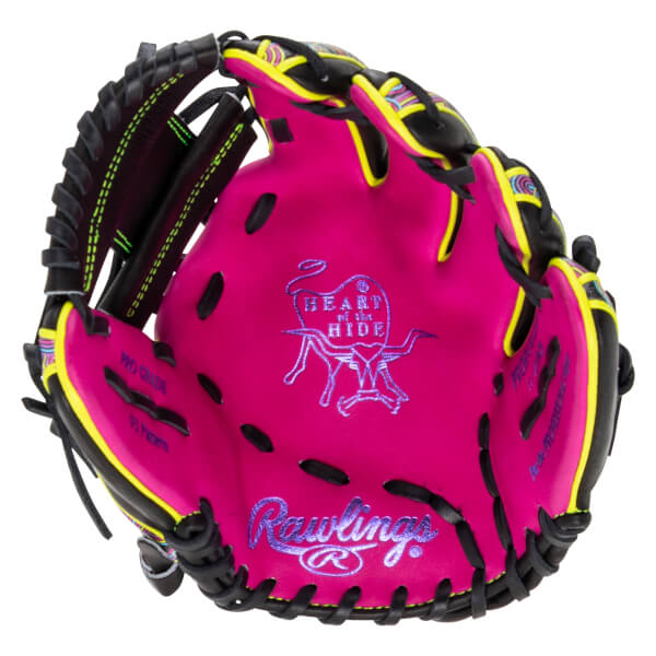 Palm view of a pink baseball glove with black and neon yellow trim, featuring purple Rawlings and HEART of the HIDE branding embroidered in the center pocket.