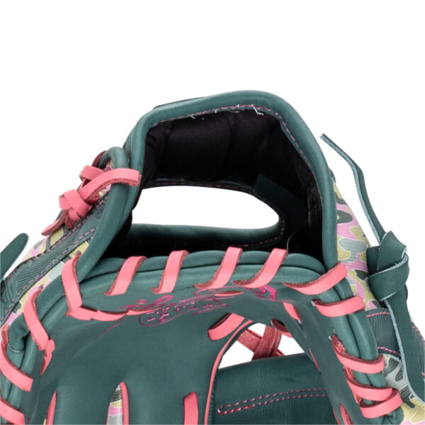 Close-up of the hand opening featuring dark green leather with pink laces, black wrist padding, and a pink signature embroidered on the inner heel.