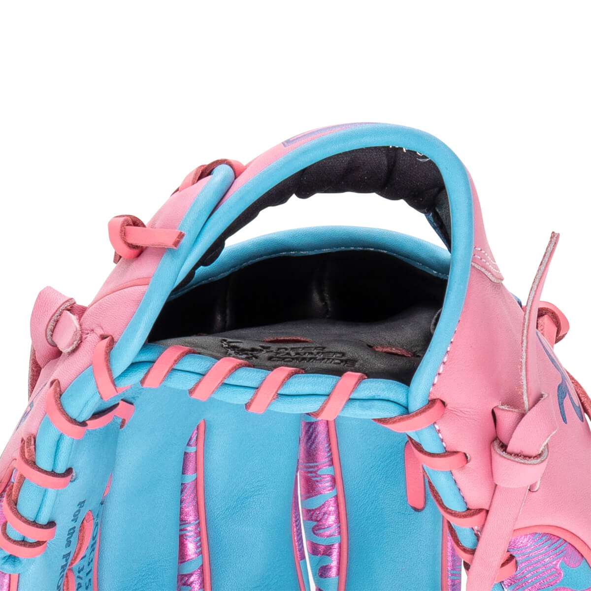 Close-up view of the wrist opening highlights pink and light blue leather with pink laces and "DEER TANNED COWHIDE" embossed on the interior lining.