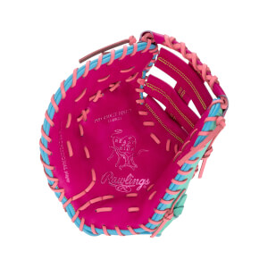 Front view of a pink 13-inch first base mitt with light blue and pink laces, featuring "Rawlings" and "Heart of the Hide" branding stamped on the palm.