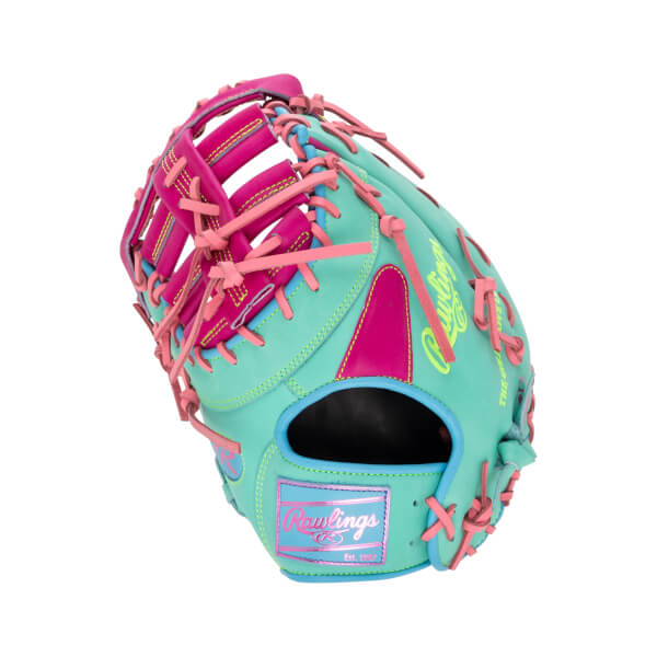 Back view of a teal first base mitt with pink laces and accents, neon green "Rawlings" embroidery, and a pink wrist patch reading "Rawlings Est. 1887".