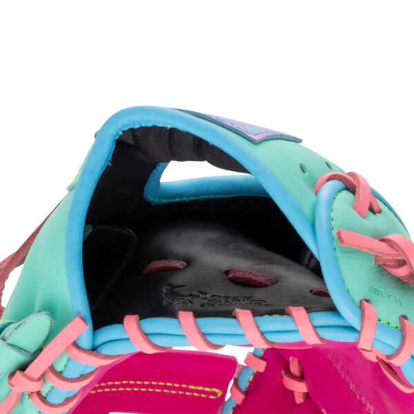 Close-up view of the hand opening shows cyan blue trim, a mint green shell, pink laces, and a black interior with BBLK23 printed on the side.
