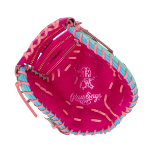 Front palm view of a pink first base mitt with multicolored laces, featuring silver "HEART of the HIDE" and "Rawlings" logos stamped on the leather.
