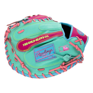 Back view of a mint green catcher's mitt with pink and blue accents, featuring the text "THE GOLD GLOVE CO." and a blue Rawlings logo patch.