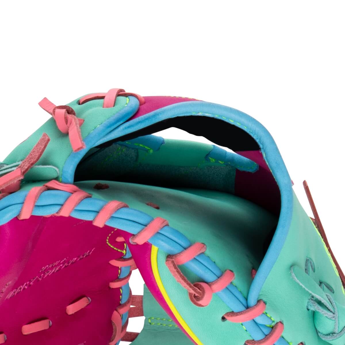 Close-up of the hand opening showing mint green, hot pink, and blue leather with pink laces and HEART OF THE HIDE embossed on the pink section.