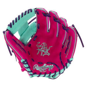 Front view of a pink baseball glove with teal and purple accents, showing the Rawlings logo and "Heart of the Hide" emblem.
