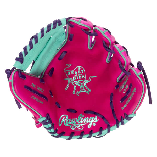 Front view of a pink baseball glove with teal and purple lacing, featuring "Rawlings" and "Heart of the Hide" logos.