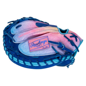 Top-down view of a blue baseball glove with a pink and blue gradient palm featuring a "Rawlings Est. 1887" patch.