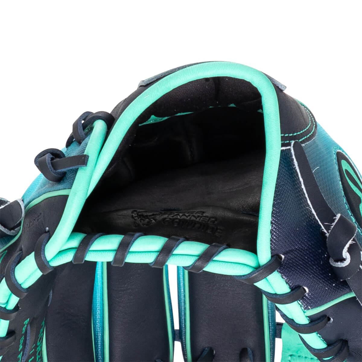 Close-up of the inside of a baseball glove showing the black leather palm with "TANNED COWHIDE" embossed and teal lacing.