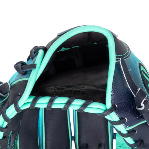 Close-up of the inside of a baseball glove showing the black leather palm with "TANNED COWHIDE" embossed and teal lacing.