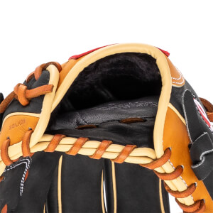 Close-up of a black and tan baseball glove with tan lacing and red trim.