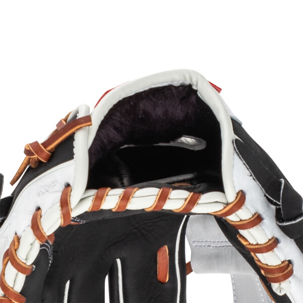 Close-up of the interior of a black and white baseball glove, showing dark fur lining and brown leather lacing.