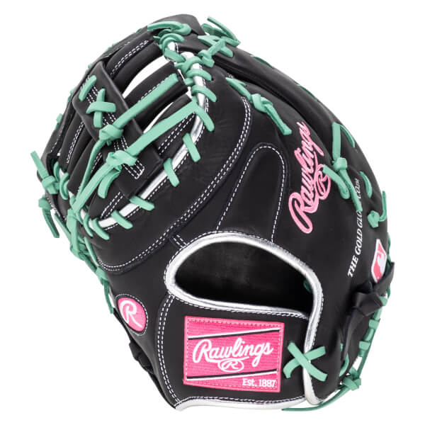 Top-down view of a black baseball glove with mint green laces, pink Rawlings logo, and "Est. 1887" text.