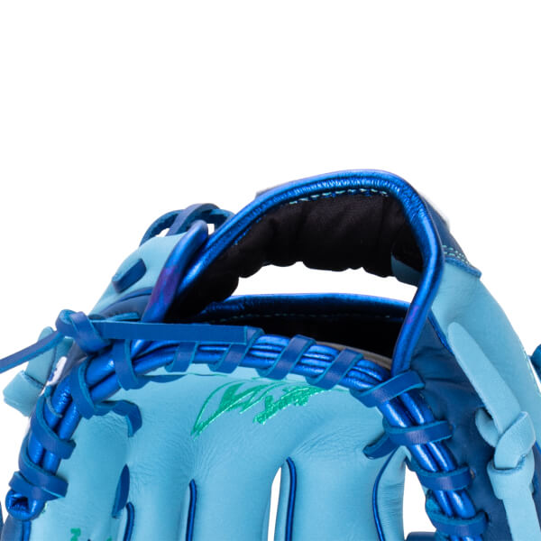Close-up of a light blue baseball glove showing blue lacing and a green embroidered design.