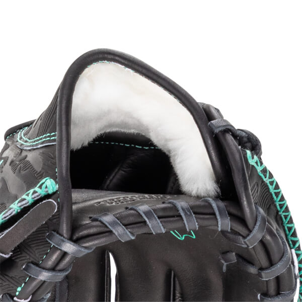 Close-up of a black baseball glove's interior, showing white padding and teal stitching.