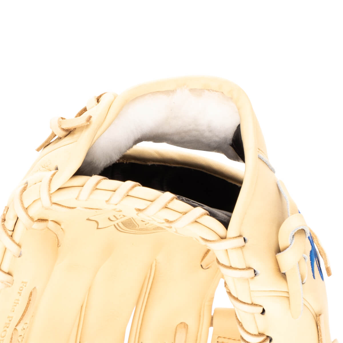 Close-up view of the interior of a tan baseball glove, showing white padding and lacing.