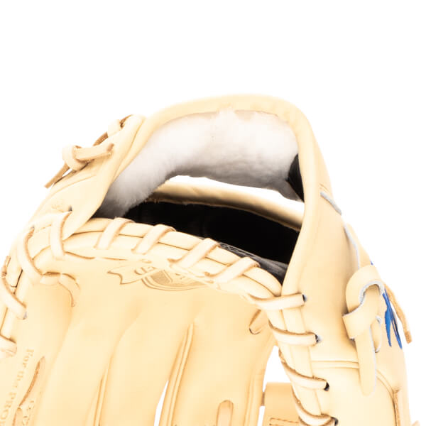 Close-up view of the interior of a tan baseball glove, showing white padding and lacing.