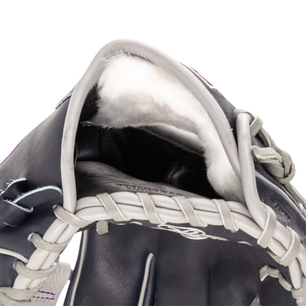 Close-up of the interior of a dark blue baseball glove, showing plush white lining and grey lacing.