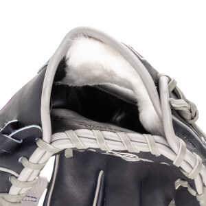 Close-up of the interior of a dark blue baseball glove, showing plush white lining and grey lacing.