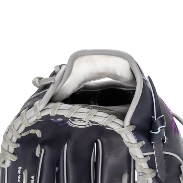 Close-up of the interior of a navy baseball glove, showing white fur lining and grey lacing.