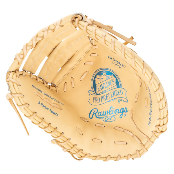 Top-down view of a tan Rawlings Pro Preferred baseball glove with blue lettering and "B. Harper Pattern" visible.