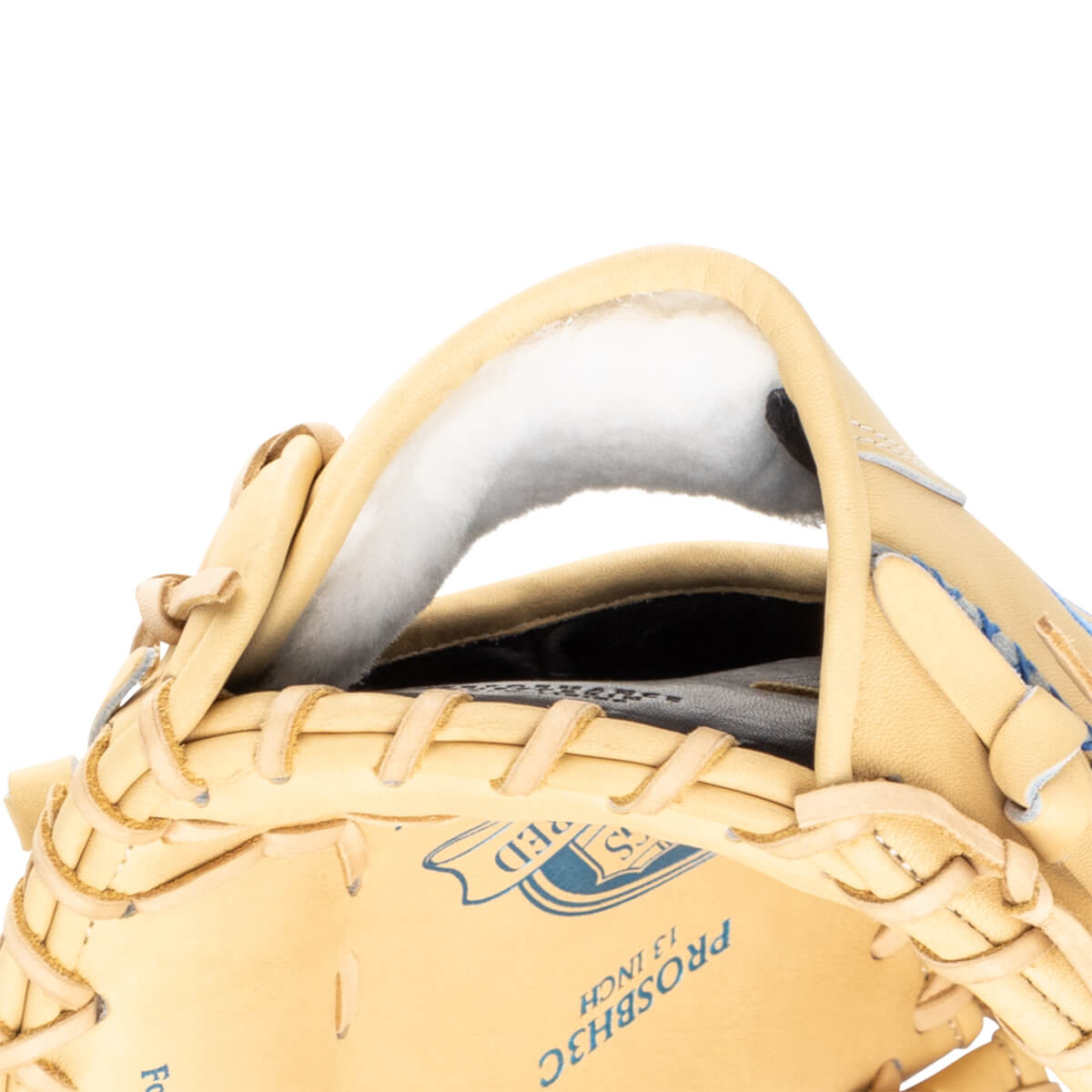 Close-up of a tan baseball glove showing the padded interior and "PROSBH3C 13 INCH" text.