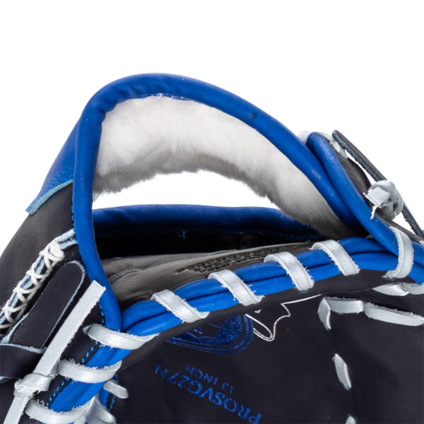Close-up of a navy baseball glove with bright blue trim and white lacing, showing the "PROSVG27N 13 INCH" text.