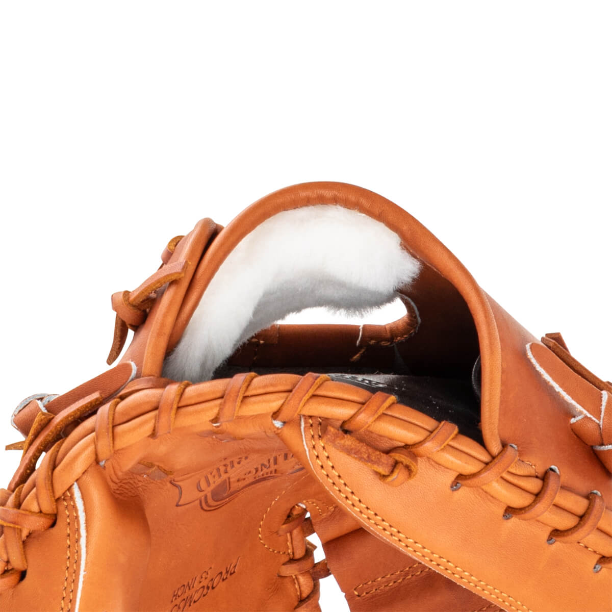 Close-up of a tan leather baseball glove's interior, showing white lining and "PROSCM33 INCH" text.
