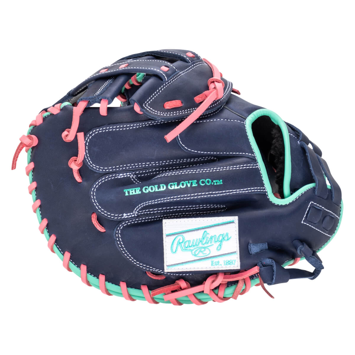 Side view of a navy baseball glove with pink and teal lacing, featuring "THE GOLD GLOVE CO.â„¢" and a Rawlings logo.