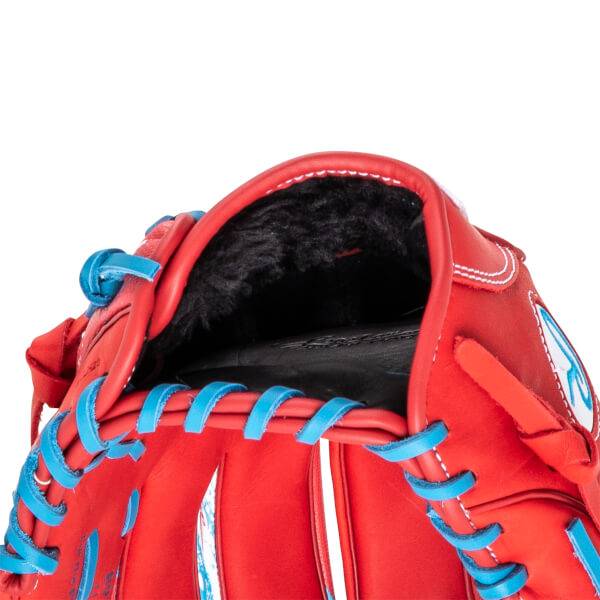 Close-up of the inside of a red baseball glove with black fur lining and bright blue lacing.